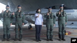 In this photo released by the Taiwan Ministry of National Defense, Taiwan's President Tsai Ing-wen is briefed during a visit to a naval station on Penghu, an archipelago of several dozen islands off Taiwan's western coast, Aug. 30, 2022.