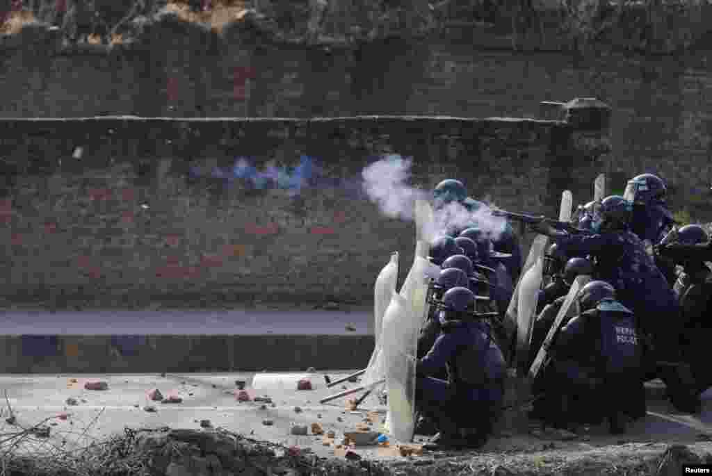 Riot police fires tear gas toward the demonstrators during a protest against the $500 million U.S infrastructure grant under the Millennium Challenge Corporation (MCC) near the parliament in Kathmandu, Nepal, Feb. 27, 2022