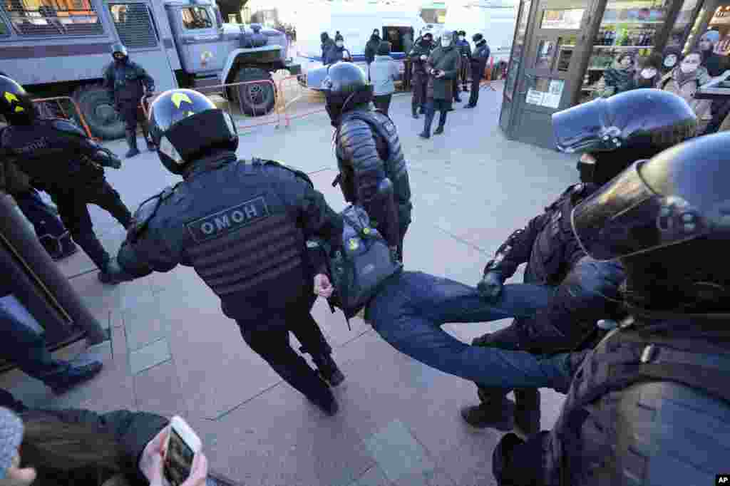 Police detain a demonstrator during a protest against Russia's attack on Ukraine in St. Petersburg, Russia.
