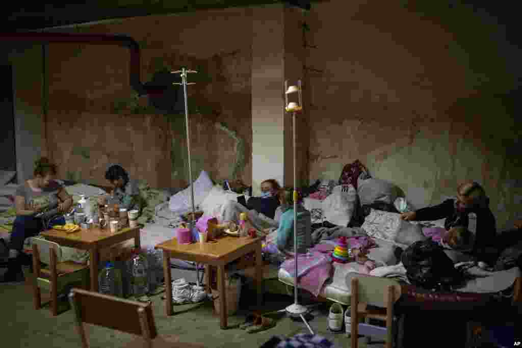 Sick children and women with their newborn babies shelter in a basement used as a bomb shelter at the Okhmadet children's hospital in central Kyiv, Ukraine.