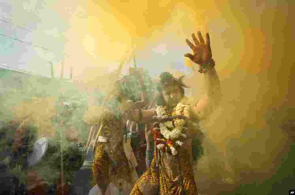 A devotee dressed as Hindu god Shiva participates in a procession on the eve of Shivratri festival, in Jammu, India.