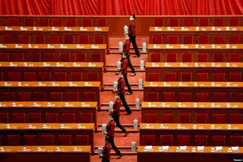 Attendants serve tea before the opening session of the Chinese People's Political Consultative Conference (CPPCC) at the Great Hall of the People in Beijing, China.