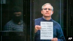 FILE - Paul Whelan, a former U.S. Marine who was arrested for alleged spying, listens to the verdict in a courtroom at the Moscow City Court, in Moscow, Russia, June 15, 2020. (Moscow News Agency photo via AP)