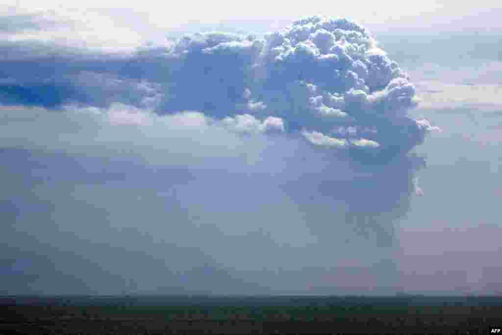 This picture taken from the Pasauran beach, Anyer in Serang, Indonesia, shows Mount Anak Krakatau spewing thick smoke into the air.