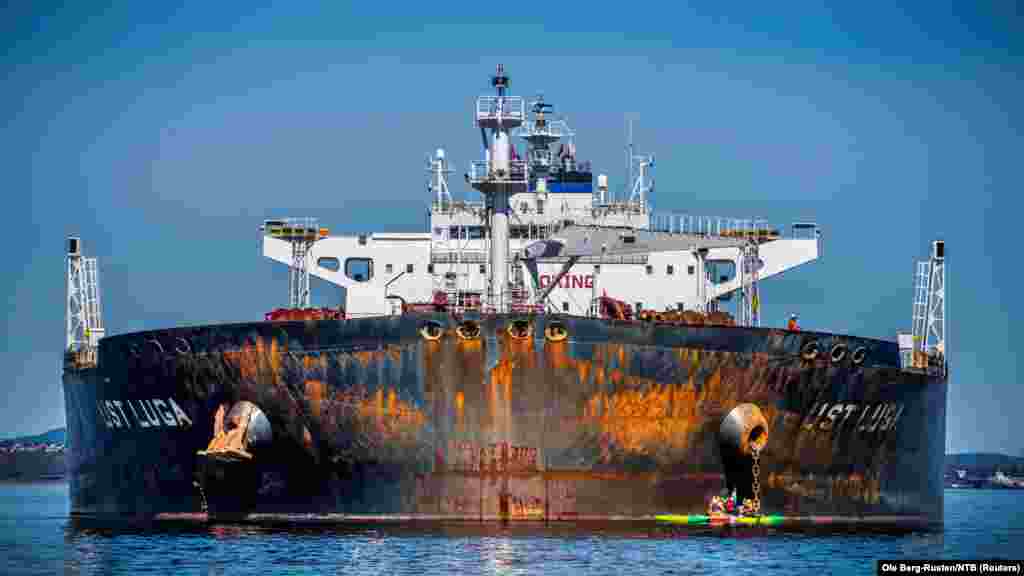 Members of Greenpeace sail next to a tanker "Ust Luga" as part of a protest against delivering Russian oil to Norway, amid Russia's invasion of Ukraine, according to Greenpeace, near Asgardstrand, Norway, April 25, 2022.