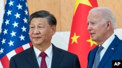 FILE - U.S. President Joe Biden, right, stands with Chinese President Xi Jinping before a meeting on the sidelines of the G-20 summit meeting, in Bali, Indonesia, Nov. 14, 2022. 
