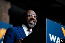 FILE - Sen. Raphael Warnock, D-Ga., speaks during a rally on Dec. 1, 2022, in Atlanta. Warnock is running against Republican Herschel Walker in a runoff election.