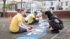Liberty Mutual employees clean and paint a playground in Boston. The company is among a number of companies in the United States that pay their employees while they volunteer. (Photo courtesy of Liberty Mutual)