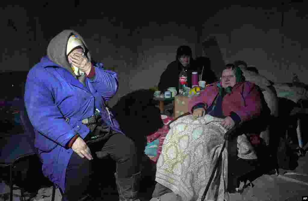 Elderly residents hide in a basement for shelter, with no electricity, water or food, in the center of the town of Irpin, some 25 km (16 miles) northwest of Kyiv, as Russian shellfire and bombardments continue.