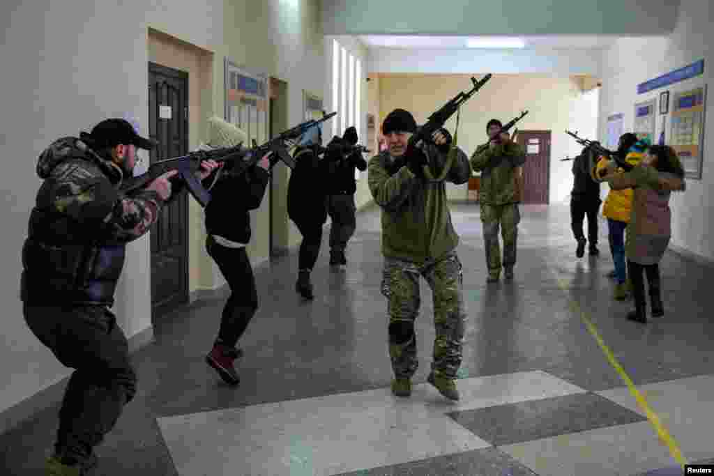 Civilians who volunteered to join the Territorial Defence Forces train on weapons, following Russia's invasion of Ukraine, in Odessa, Ukraine.