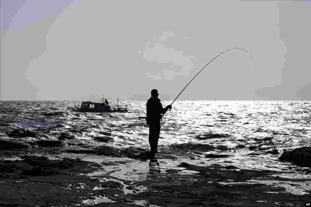 A man fishes in the tidal pools on Enoshima Island in Fujisawa, south of Japan.