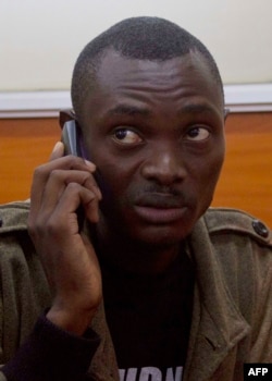 FILE - Norman Tumuhimbise, a member of a Ugandan activist group, sits inside the Kampala Capital City Authority court, Sept. 5, 2014.