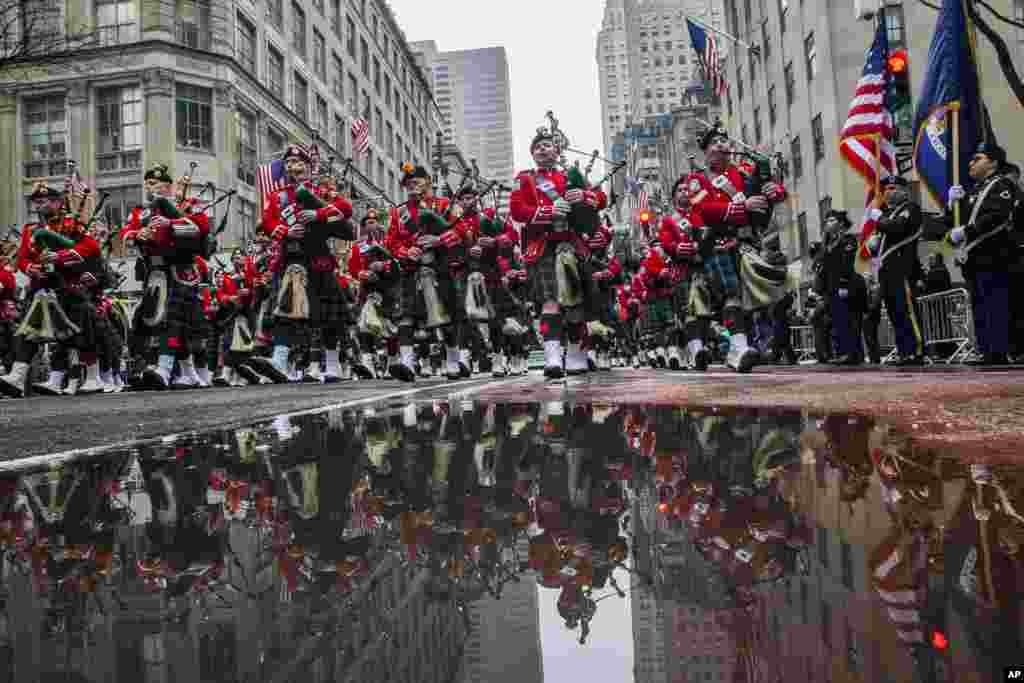 Bagpipers march up Fifth Avenue past St. Patrick Cathedral during the St. Patrick's Day Parade in New York.