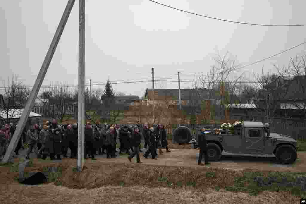 People attend a funeral ceremony for Ukrainian servicemen Roman Rak and Mykola Mykytiuk in Starychi, Ukraine.