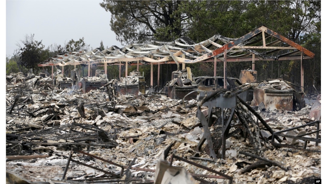 The charred remains of an apartment complex remain that burned from a wildfire two days earlier, Sept. 14, 2015, in Middletown, Calif.