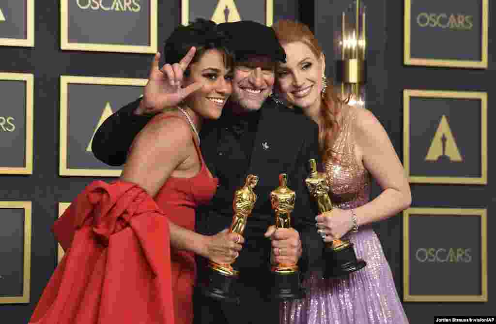 Ariana DeBose (L) winner of the award for the best actress in a supporting role for "West Side Story", Troy Kotsur (center) winner of the award for the best actor in a supporting role for "CODA", and Jessica Chastain (R) winner of the best actress in a leading role for "The Eyes of Tammy Faye," pose in the press room at the Oscars, March 27, 2022, at the Dolby Theatre in Los Angeles.