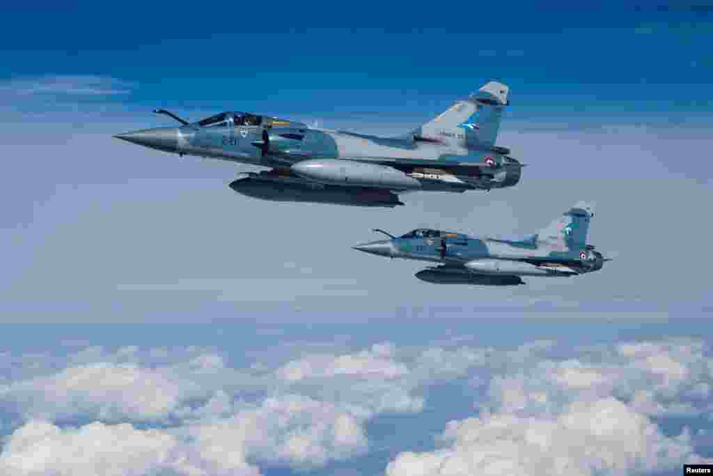 Two Mirage 2000-5F fighter jets of the French Air Force are seen next to an Airbus A330 MRTT "Phenix" in the airspace of Poland as part of NATO's enhanced Air Policing (eAP) to secure the skies over Baltic allies.