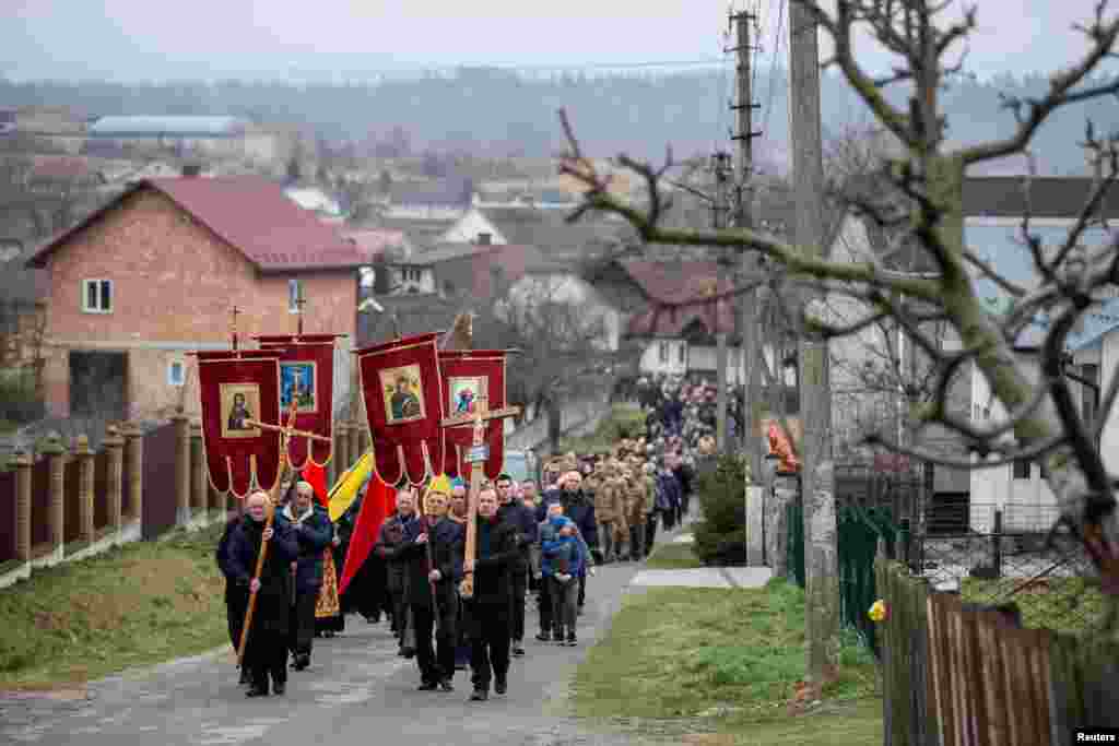 People attend the funeral of a Ukrainian soldier, Vasyl Vekliuk, 59, who died in a shelling near Popasna in the Luhansk region, amid Russia's invasion of Ukraine.