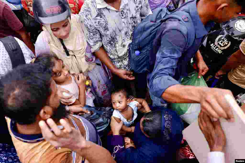 People get into ferries at Bangladesh Inland Water Transport Corporation Shimulia Ferry Ghat to go home ahead of Eid al-fitr, in Munshiganj, Bangladesh.