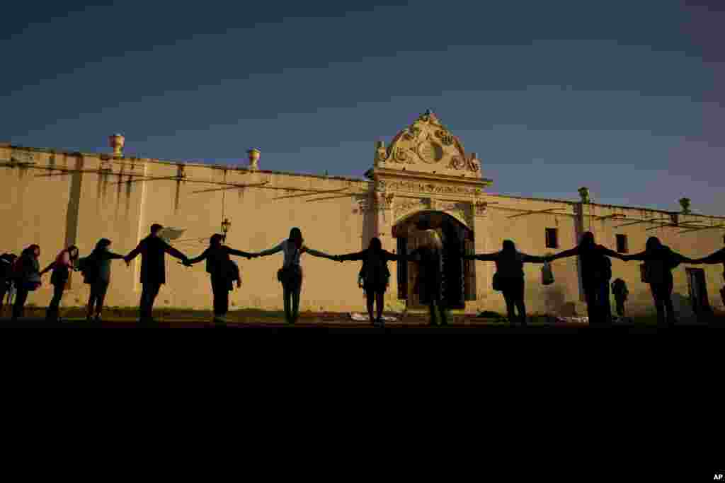 Women holding hands, rally outside the San Bernardo Convent in Salta, Argentina, May 3, 2022, in support of the convent's cloistered nuns who have accused the Archbishop of Salta province Mario Antonio Cargnello and other church officials of gender-based psychological and physical violence.