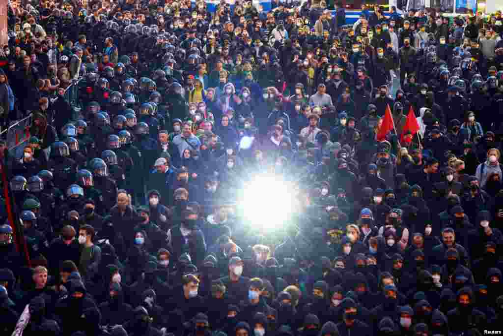 Police officers surround demonstrators as they take part in a May Day protest in Berlin, Germany, May 1, 2022.