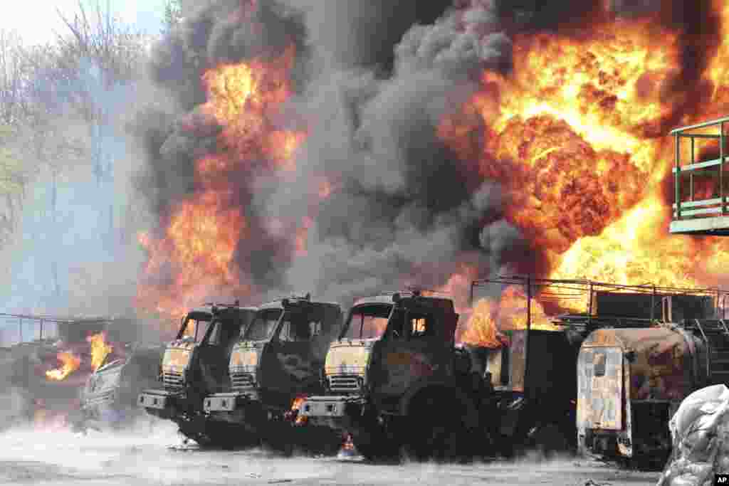 Vehicles are on fire at an oil depot after missiles struck the facility in an area controlled by Russian-backed separatist forces in Makiivka, 15 km (94 miles) east of Donetsk, eastern Ukraine.