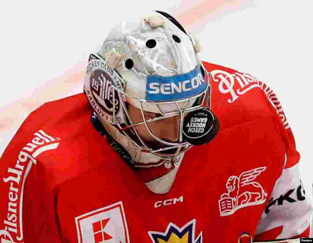 Czech Republic's Stepan Lukes reacts after the puck gets stuck in his helmet grill during the Euro Hockey Tour match between Austria and Czech Republic in Ostrava, Czech Republic.