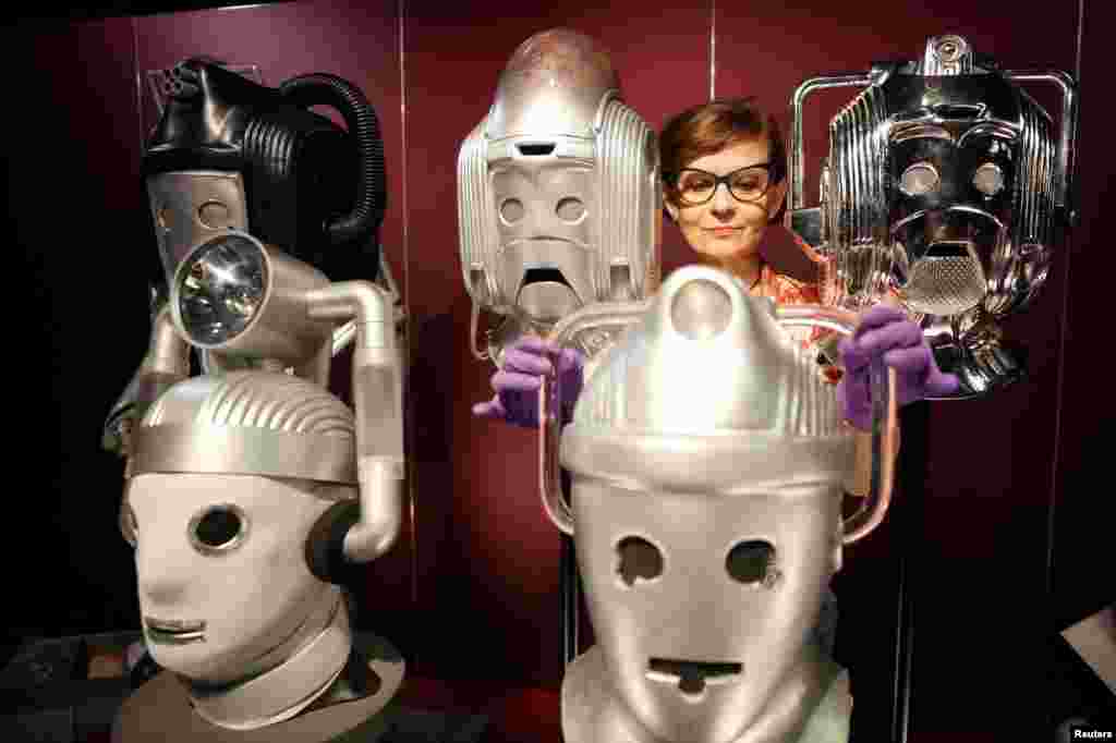 Sculpture conservator Marisa Prandelli adjusts a display of heads of "Cybermen" in the monster vault at the "Doctor Who: Worlds of Wonder" exhibition, which opens at the World Museum later this month, in Liverpool, Britain.