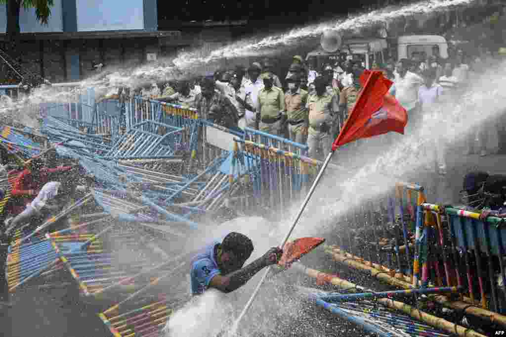 Police use a water canon to disperse activists of the Akhil Bharatiya Vidyarthi Parishad (ABVP), the students wing of the Bharatiya Janata Party (BJP), during a protest against West Bengal's state government over alleged irregularities in the Staff Selection Commission recruitment process, in Kolkata, India.