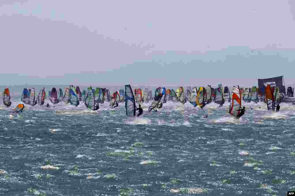Competitors take the start of the first stage of the 20th edition of the Defi Wind windsurfing competition in the Mediterranean Sea, off the coat of Gruissan in southern France.