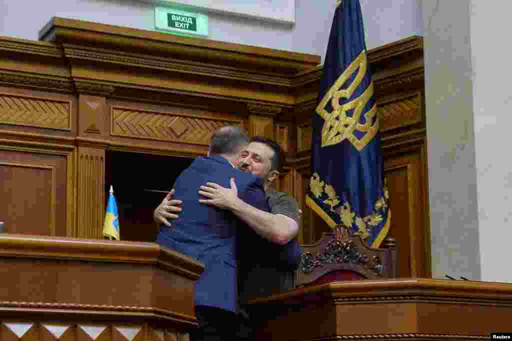 Polish President Andrzej Duda embraces Ukraine's President Volodymyr Zelenskiy during a session of Ukrainian parliament in Kyiv as Russia's attack on Ukraine continues.