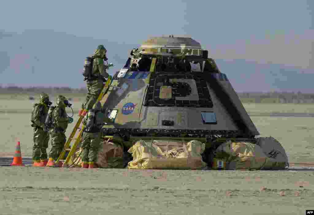 In this handout image courtesy of NASA, Boeing and NASA teams work around Boeing's CST-100 Starliner spacecraft after it landed at White Sands Missile Range's Space Harbor, May 25, 2022, in New Mexico.