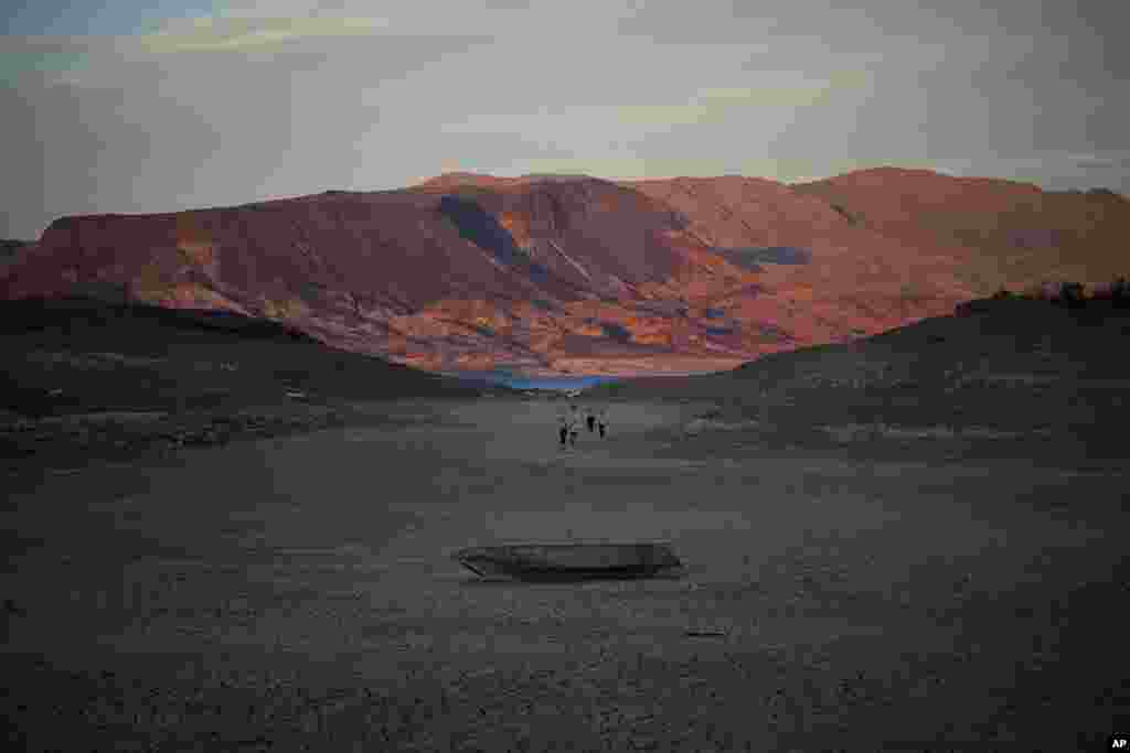 A formally sunken boat sits on cracked earth hundreds of feet from what is now the shoreline on Lake Mead at the Lake Mead National Recreation Area, near Boulder City, Nevada. A second set of human remains has emerged within a week from the depths of the drought-stricken Colorado River reservoir. 