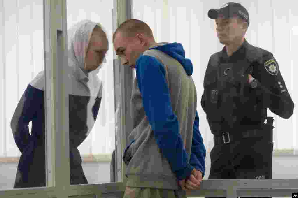 Russian Sgt. Vadim Shishimarin listens to his translator during a court hearing in Kyiv, Ukraine. The 21-year old soldier facing the first war crimes trial since the start of the war in Ukraine, plead guilty on May 18 to killing an unarmed civilian.