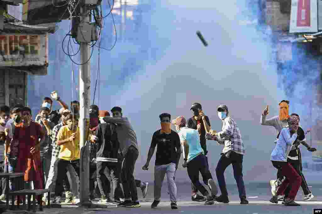 Protesters take part in a demonstration amid tear gas smoke fired by Indian security forces to disperse them in Srinagar, over the sentencing hearing of pro-independence party Jammu Kashmir Liberation Front chairman Yasin Malik.