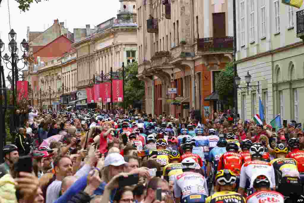 Spectators cheer as riders take the start of the third stage of the Giro d'Italia 2022 cycling race, 201 kilometers between Kaposvar and Balatonfured, Hungary.