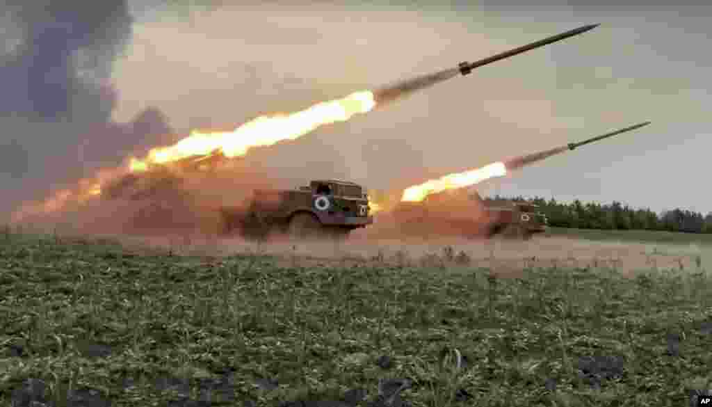 In this handout photo released by Russian Defense Ministry Press Service released, the Russian military's Uragan multiple rocket launchers fire rockets at Ukrainian troops at an undisclosed location.