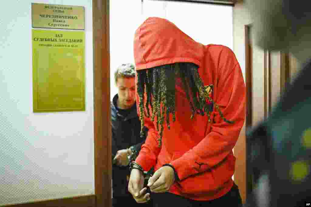 WNBA star and two-time Olympic gold medalist Brittney Griner leaves a courtroom after a hearing, in Khimki just outside Moscow, Russia. Griner was detained at the Moscow airport in February after vape cartridges containing oil derived from cannabis were allegedly found in her luggage, which could carry a maximum penalty of 10 years in prison. 