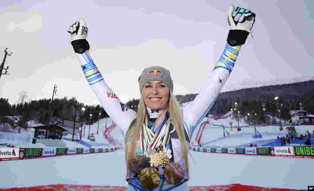 United States' Lindsey Vonn poses with her career's medals in the finish area after the women's downhill race, at the alpine ski World Championships in Are, Sweden.