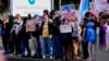 FILE - Transgender rights supporters protest outside of Seattle Children's Hospital after it postponed some gender-affirming surgeries for minors following an executive order by President Donald Trump, Feb. 9, 2025, in Seattle.
