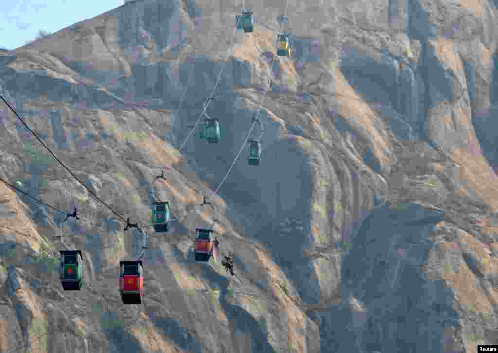 Indian Air Force personnel carry out a mid-air rescue mission after Sunday's cable-car collision in Deoghar district in the eastern state of Jharkhand, India.