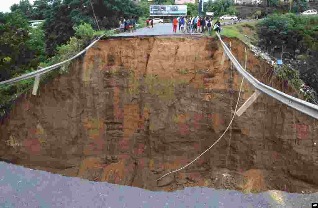 A bridge is swept away due to prolonged rains and flooding in Ntuzuma, outside Durban, South Africa.