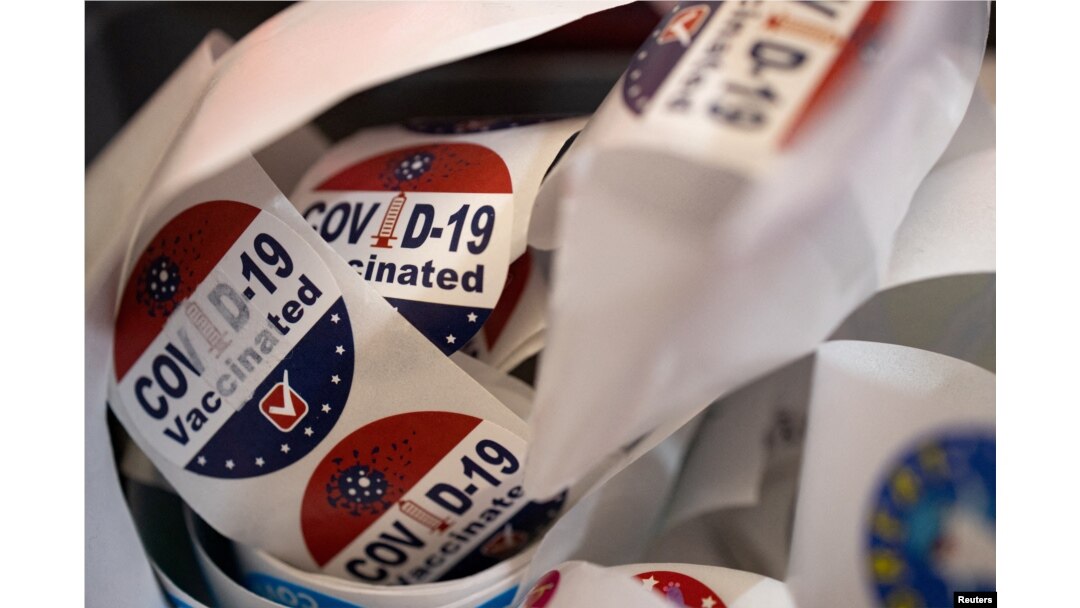 FILE - Patients receive stickers after receiving the coronavirus disease booster vaccine at Skippack Pharmacy in Schwenksville, Pennsylvania, Sept. 8, 2022.