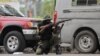 FILE - A soldier positions himself outside the military base near the presidential palace in Port-au-Prince, Haiti, after gangs waged intense gun battles, shuttering main avenues and a municipal market in the downtown area, July 27, 2022. 