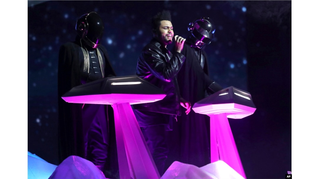 The Weeknd, center, and Daft Punk perform at the 59th annual Grammy Awards, Feb. 12, 2017.