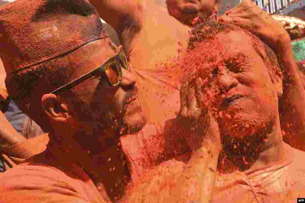 Revelers smeared in vermillion powder take part in the Bisket Jatra festival in Thimi, Nepal, on the outskirts of Kathmandu.