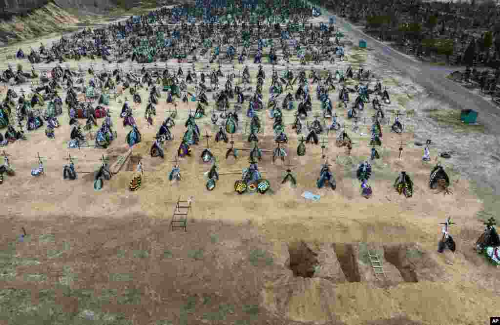 A general view of the cemetery in Irpin where three dug graves await the next funerals in the outskirts of Kyiv, Ukraine.