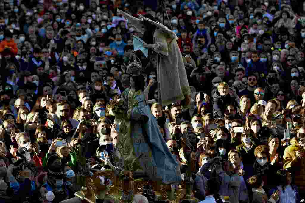 7-year-old Veronica Serrano, secured by a harness, is transported in the air as she unveils the face of a statue of the Virgin Mary during the Easter Sunday ceremony ''Descent of the Angel'', part of Holy Week in Tudela, northern Spain.