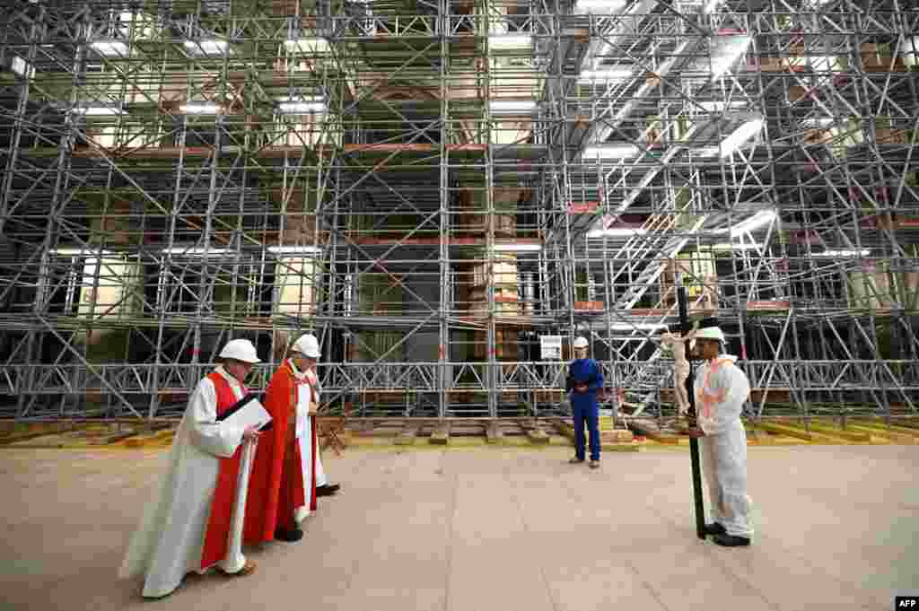 Local clergy carry out a Good Friday meditation prayer at Notre-Dame in Paris, marking the third anniversary of a fire that severely damaged the cathedral.