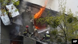 Los bomberos trabajan para extinguir el fuego en un edificio de apartamentos después de un ataque ruso en Kharkiv, Ucrania, el 17 de abril de 2022.